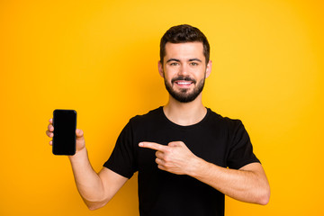 Positive cool guy promoter hold cellphone touchscreen point index finger recommend modern...