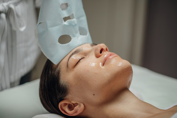 Cosmeotologist Putting a Facial Mask