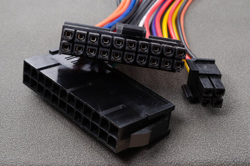 24 Pin dual PSU splitter power supply extension cable for ATX isolated on white close up. Adapter allows two power supply units for one PC. Mining ATX Splitter close up.