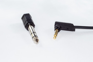 6.35 mm male to 3,5 mm female jack adapter and mii jack audio cable. Isolated on white.