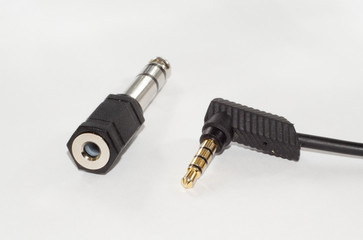 6.35 mm male to 3,5 mm female jack adapter and mii jack audio cable. Isolated on white.