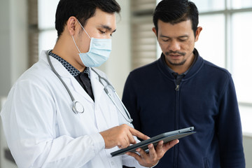 Close up of a doctor checking patient information via tablet.