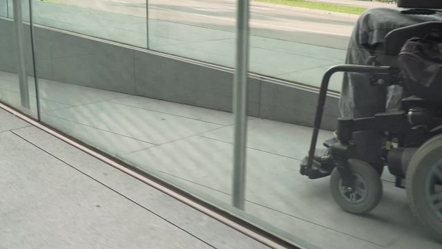 4k resolution follow of a man on electric wheelchair using a ramp. Accessibility concept
