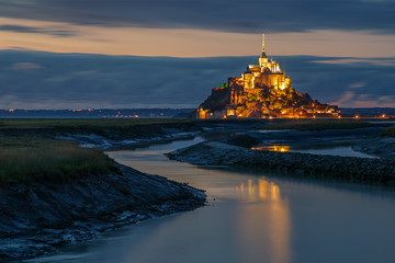 Obraz premium Normandy, France. The illuminated Mont Saint Michel is reflected on the water