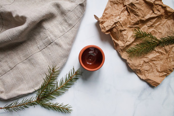 ceramic mug clay red on light marble background top view on Kraft paper and fir branches