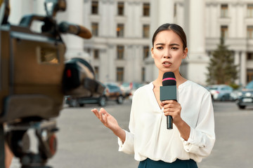 The whole truth and nothing but the truth. TV reporter presenting the news outdoors. Journalism industry, live streaming concept. - obrazy, fototapety, plakaty