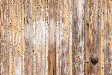 Obraz premium Background from a wall of boards with peeling off old paint. Key lock. Copy space.