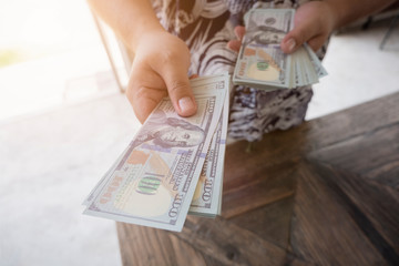 Man handed dollar bills to you, American money in hand, Cash in hands, Income and Business concept.
