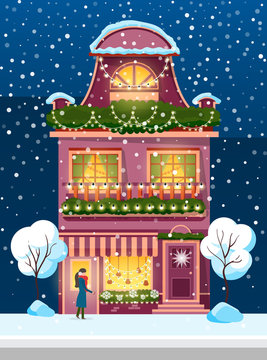 Snowfall in city or town vector. Woman wearing earmuffs and warm clothes standing by home. Building exterior decorated by wreaths and garlands. Wintertime facade of house with wreath flat style