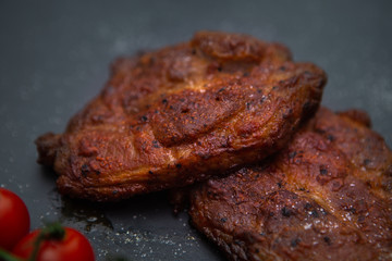  Sliced ​​ Piglet steak. Succulent meat of piglet on black marble background.