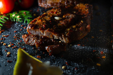  Sliced ​​ Piglet steak. Succulent meat of piglet on black marble background.
