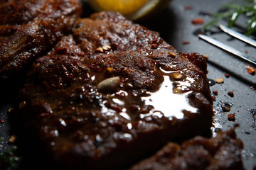 Sliced ​​ Piglet steak. Succulent meat of piglet on black marble background.