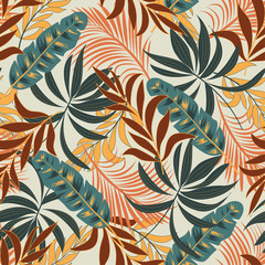 Summer seamless tropical pattern with bright red and yellow plants and leaves on beige background. Beautiful print with hand drawn exotic plants.  Tropic leaves in bright colors.