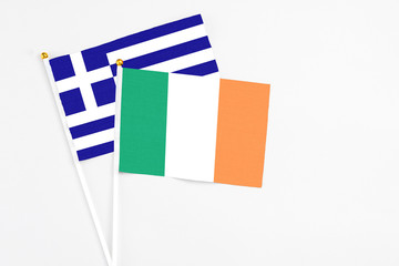 Ireland and Greece stick flags on white background. High quality fabric, miniature national flag. Peaceful global concept.White floor for copy space.