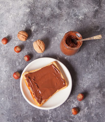 Bread toast with chocolate cream butter on the concrete background