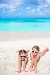 Adorable little girls walking on the beach