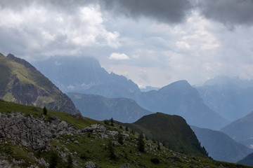 Clouds over the mountains. Mountain alpine landscape. Dolomites, Italy