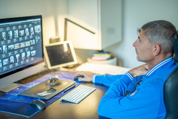 Fototapeta na wymiar Man working at home computer in front of big screen