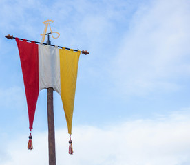 Dutch Flag of traditional festival Named Carnaval s'Hertogenbosch, Oeteldonk in the blue sky, red,white and yellow