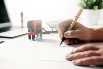 Lawyer working in office. Notary signs document