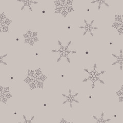 Dark snowflakes ob calm beige background. Seamless winter pattern.