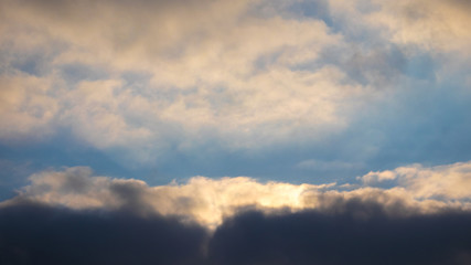 Fototapeta na wymiar Dark dramatic sky with reflections of sun on clouds_