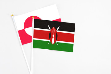Kenya and Greenland stick flags on white background. High quality fabric, miniature national flag. Peaceful global concept.White floor for copy space.