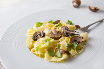 Spaghetti reginelle pasta with mushrooms on grey stone table. Tasty healthy dinner. Close up. Selective focus.