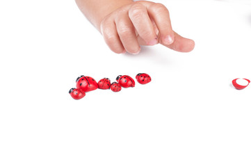 Red ladybug and children's hand isolated on white background
