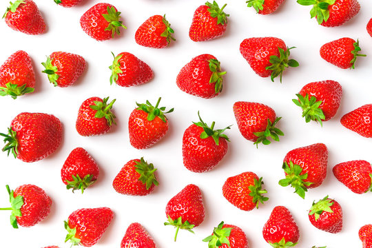 Background made from red ripe strawberry on the light background, close up shoot