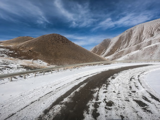 gravel road on snow mountain