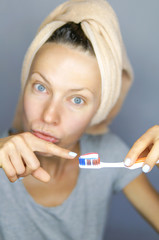 Woman brushing cleaning teeth. Morning routine: girl with toothbrush. Oral hygiene