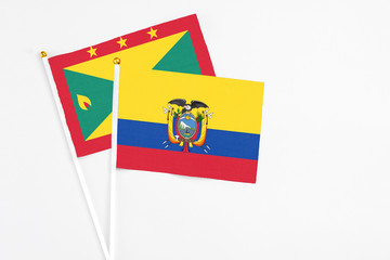 Ecuador and Grenada stick flags on white background. High quality fabric, miniature national flag. Peaceful global concept.White floor for copy space.