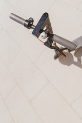 Detail of electric scooter. Smart scooter casts a shadow on a sunny day outside