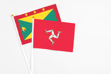 Isle Of Man and Grenada stick flags on white background. High quality fabric, miniature national...