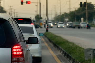 ฺBrake of car on asphalt roads during rush hours for travel or business work. stop by traffic light control.
