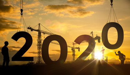 Silhouette construction site,Cranes building construction 2020 year sign