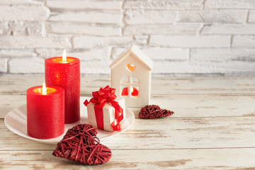 Romantic background for valentines day in red colores with candles, hearts and roses flowers.