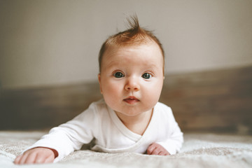 Cute baby infant crawling in bedroom adorable kid portrait family lifestyle 3 month old child close-up