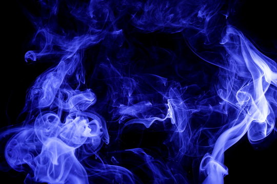 Blue smoke on black background