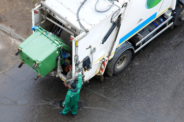 Man operates garbage collection truck, top view