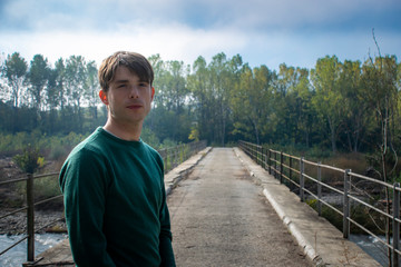 man walking in the middle of a bridge