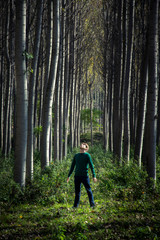lonely man standing on an enchanted forest