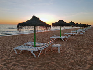 Beach umbrellas on the beach at Aruba Island in the Caribbean Sea