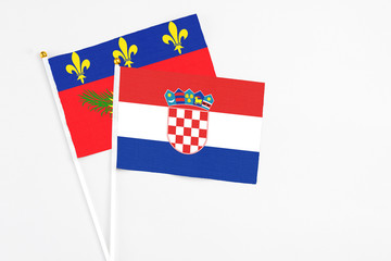 Croatia and Guadeloupe stick flags on white background. High quality fabric, miniature national flag. Peaceful global concept.White floor for copy space.