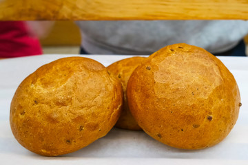 Hamburger bread muffins on white table.