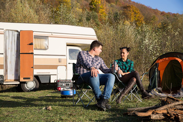 Couple enjoying their holiday in a mountain camps site