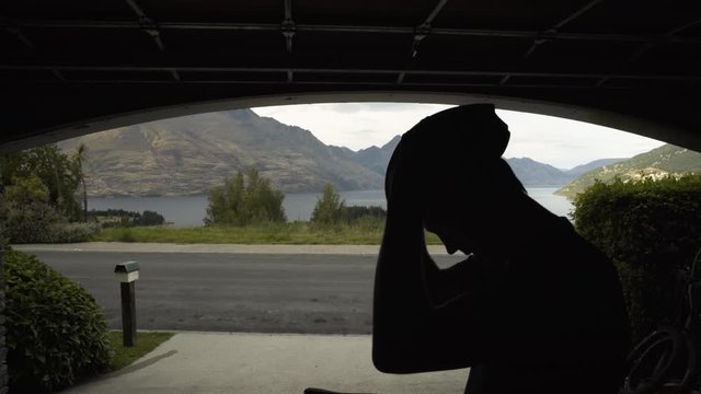 Silhouette male preparing bike ride workout Lake Wakatipu