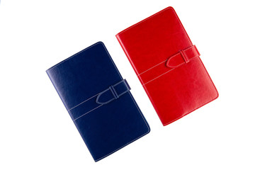 Red and blue notebooks with inserts and magnetic fasteners