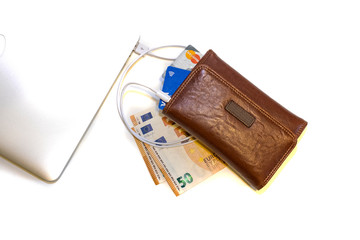 Laptop and wallet with money and bank cards, online wallet and digital money. Payment via the Internet.